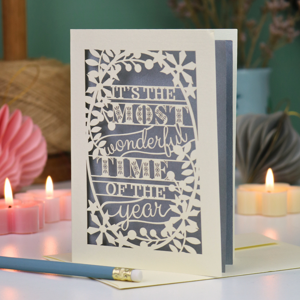A laser cut Christmas card in cream with decorative text, 'It's the most wonderful time of the year'