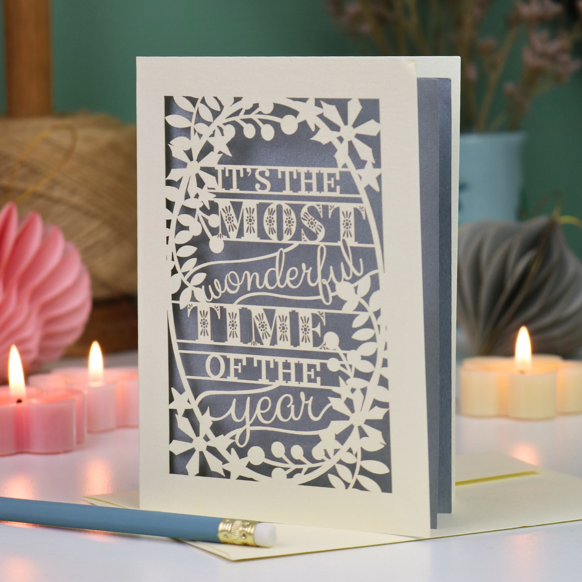 A laser cut Christmas card in cream with decorative text, 'It's the most wonderful time of the year'