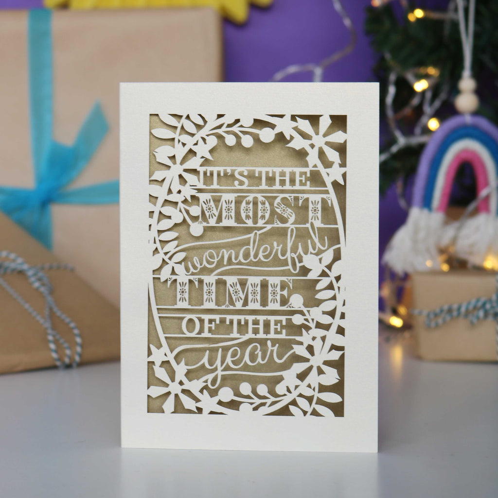 Decorative laser cut Christmas card with 'It's the most wonderful time of the year' text 