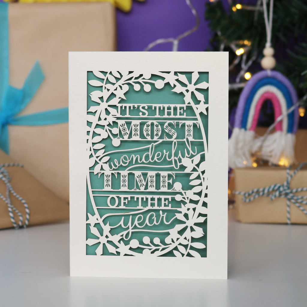 Decorative laser cut Christmas card with 'It's the most wonderful time of the year' text 