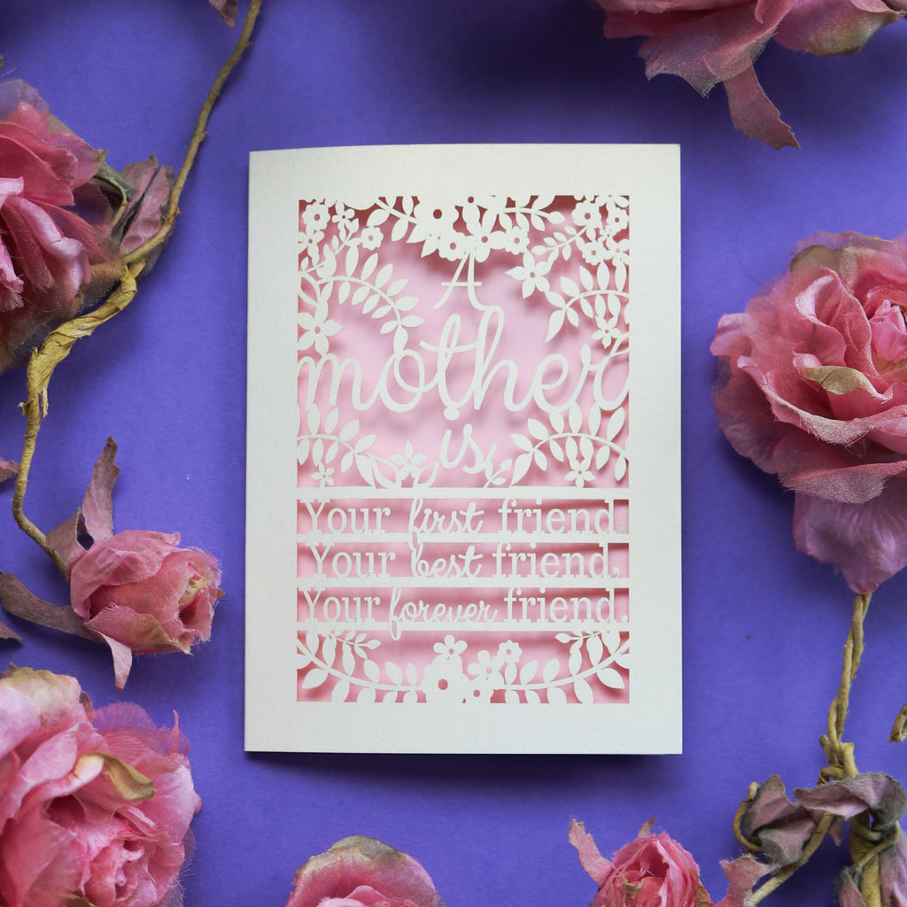 A paper cut mother's day card that says "A mother is your first friend, your best friend, your forever friend."