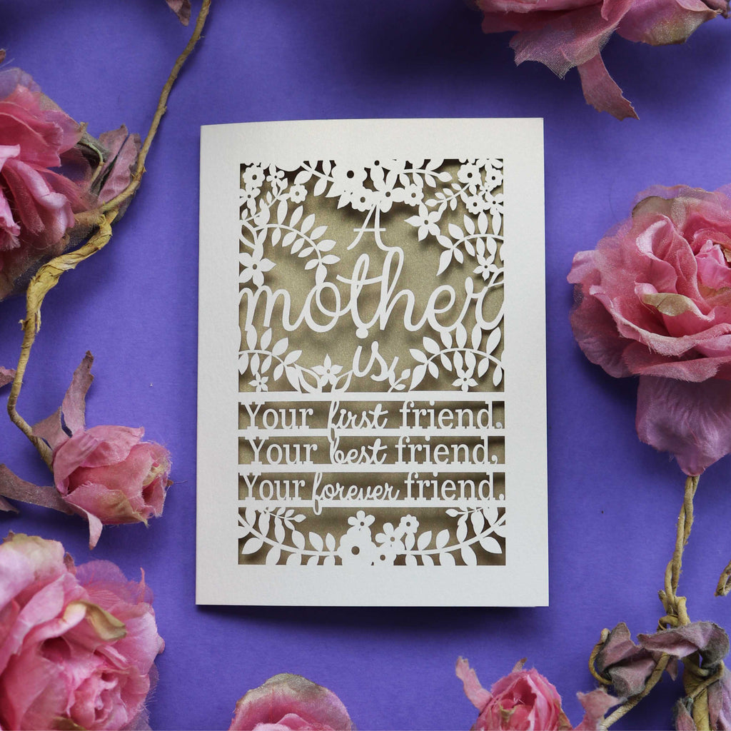 A paper cut Mothering Sunday card that says "A mother is your first friend, your best friend, your forever friend."