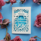 A mother's day card laser cut from cream card with a blue paper background
