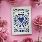 A cream laser cut Mothering Sunday card that says "With love on Mothering Sunday". Card has a heart and flower details and a violet paper insert