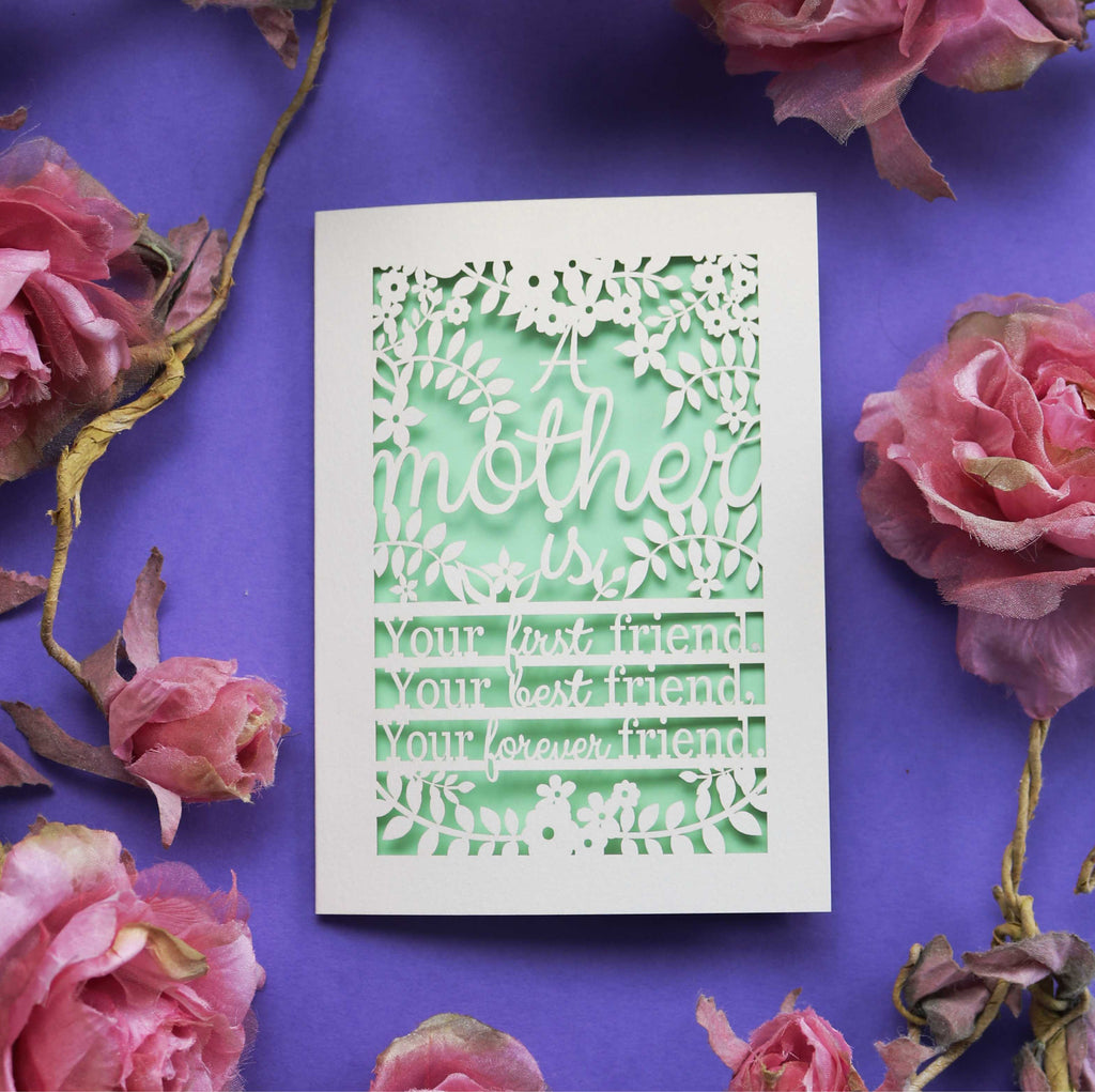 A cut out mothering sunday card that says "A mother is your first friend, your best friend, your forever friend."