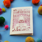 90th Birthday card with bee design and colourful pom-poms on a blue background