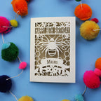 90th Birthday card with bee design and colourful pom-poms on a blue background