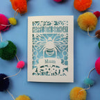 90th Birthday card with bee design and colourful pom-poms on a blue background