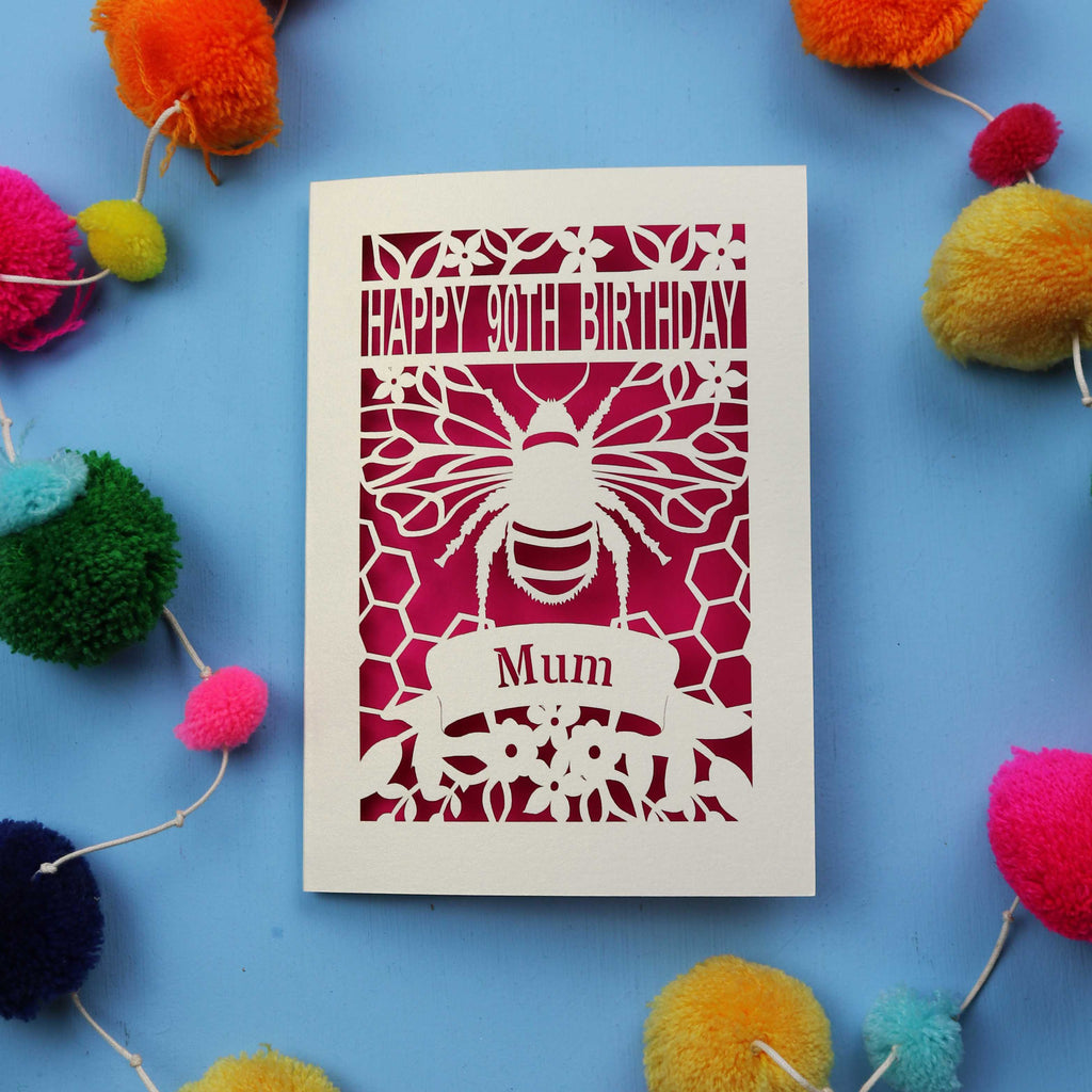 90th Birthday card with bee design and colourful pom-poms on a blue background