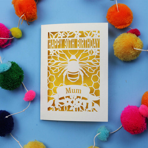 90th Birthday card with bee design and colourful pom-poms on a blue background