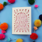 Paper cut Mummy Christmas card with 'Merry Christmas to my Mummy' text on a blue background with colourful pom-poms.