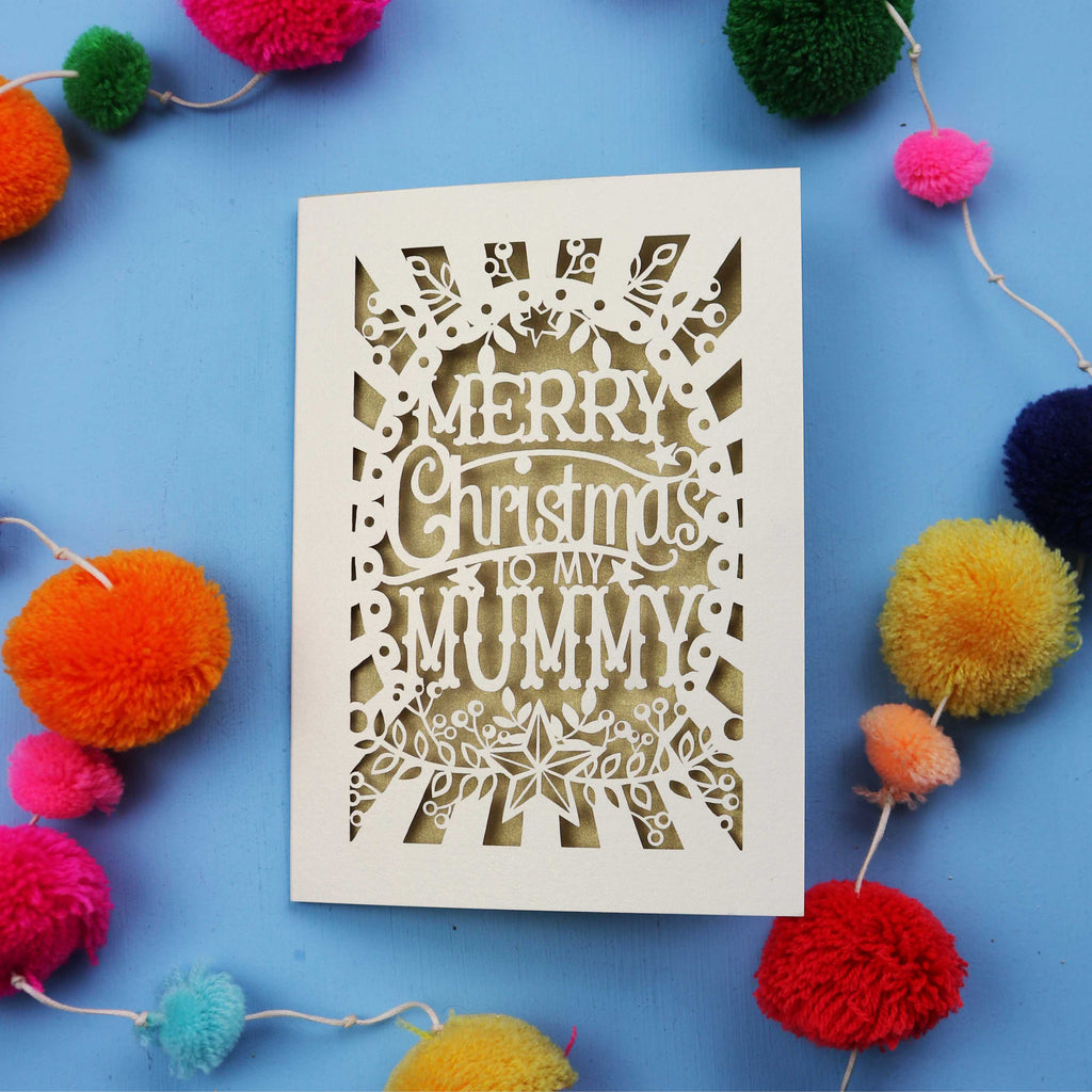 Unique laser cut Mummy Christmas card with 'Merry Christmas to my Mummy' text on a blue background with colourful pom-poms.