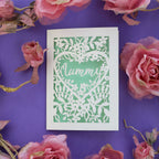 A cut out mother's day card with a flower border and "Mummy"