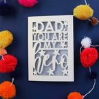 A cream card for fathers day with the words "Dad, you are my hero"