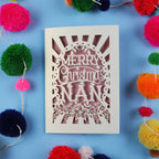 Nan Christmas card with 'Merry Christmas Nan' text surrounded by colourful pom-poms on a blue background