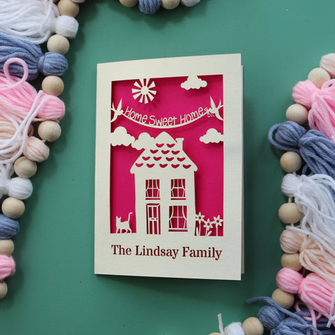 A personalised laser cut new home card, made in the UK. Design features a house and the words "Home Sweet Home". The bottom of the card is personalised with the name of the recipient.  - A6 / Shocking Pink