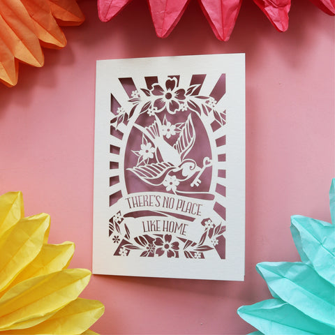 A fun and beautiful house warming card featuring a bird holding a key and the words "There's no place like home." - 