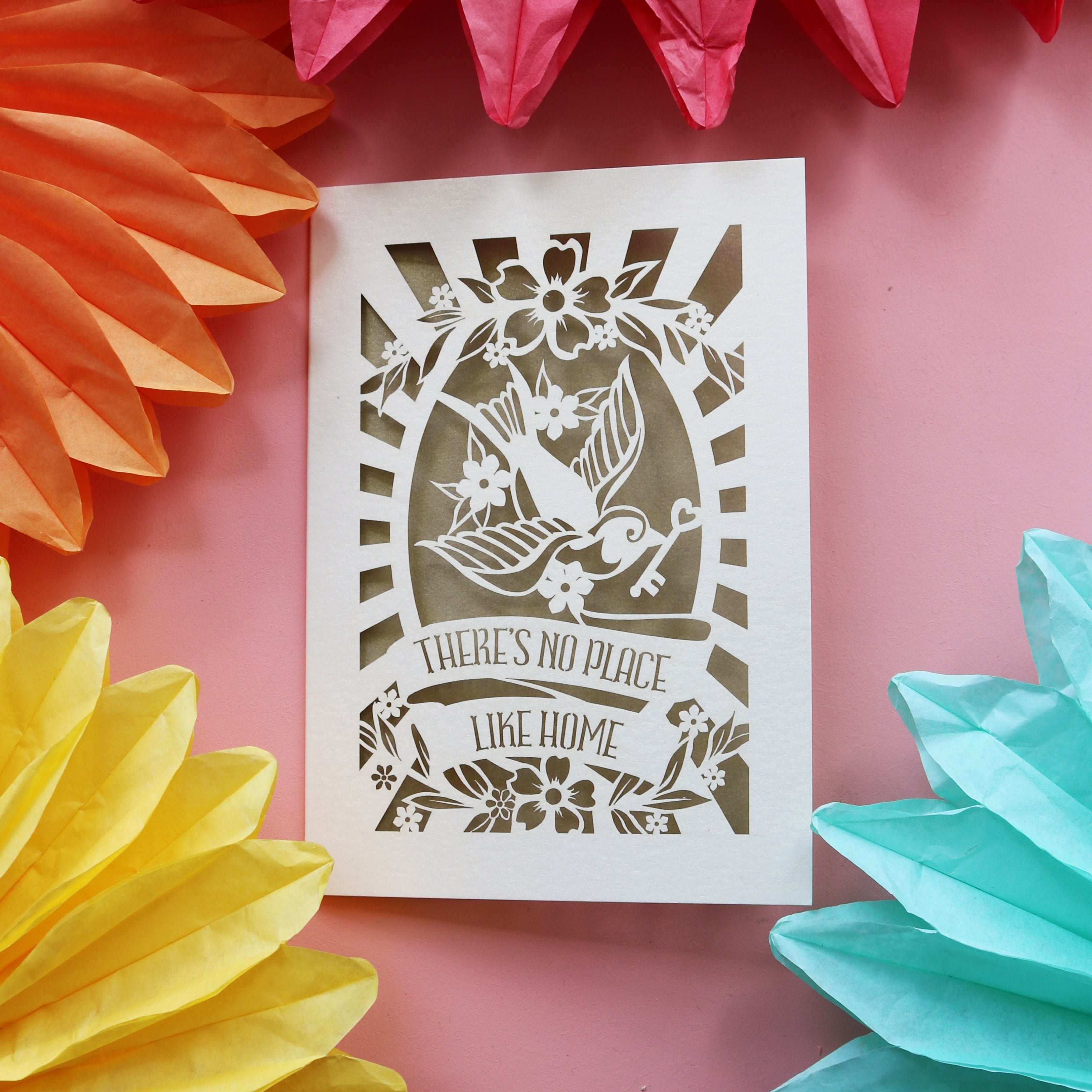 Cream and gold leaf new home cards featuring a bird holding a key and the words "There's no place like home."