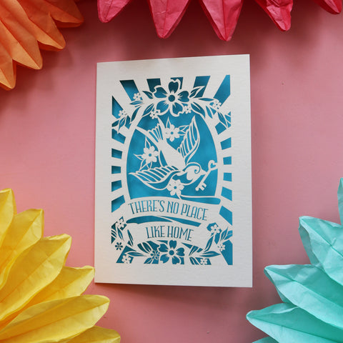 A card for first new home buying featuring a bird holding a key and the words "There's no place like home." - A6 (small) / Peacock Blue