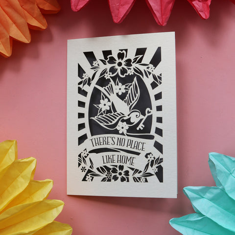 A housewarming card featuring a bird holding a key and the words "There's no place like home." - A6 (small) / Urban Grey