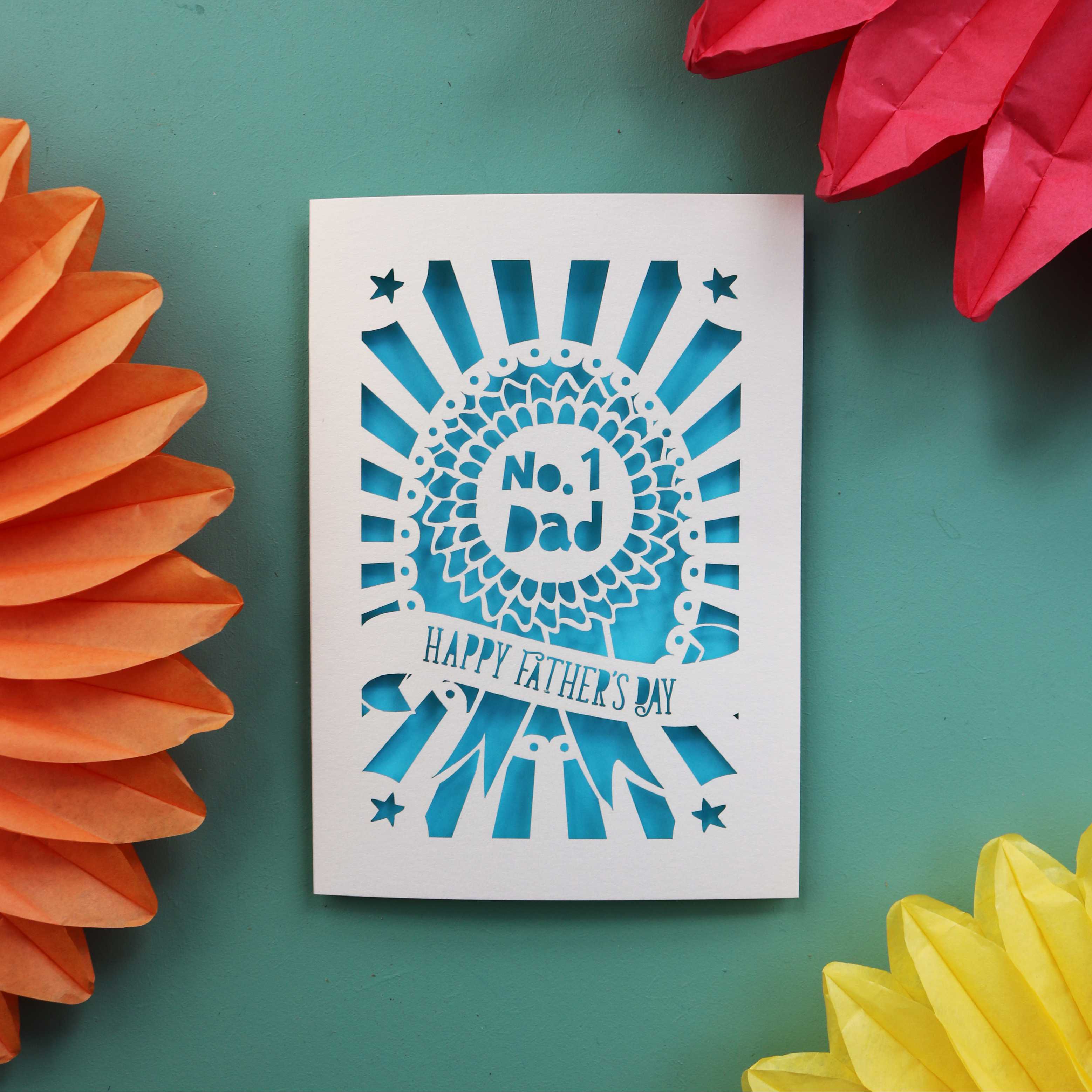 A cream and blue Laser cut Father's Day card featuring a rosette that says "No. 1 Dad" and "Happy Father's Day