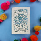 Personalised husband anniversary card with decorative heart design on a blue background with colourful pom-poms.