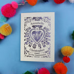 Personalised anniversary card with decorative heart design on a blue background with colourful pom-poms.
