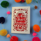 Personalized Our First Christmas card with decorative elements on a blue background