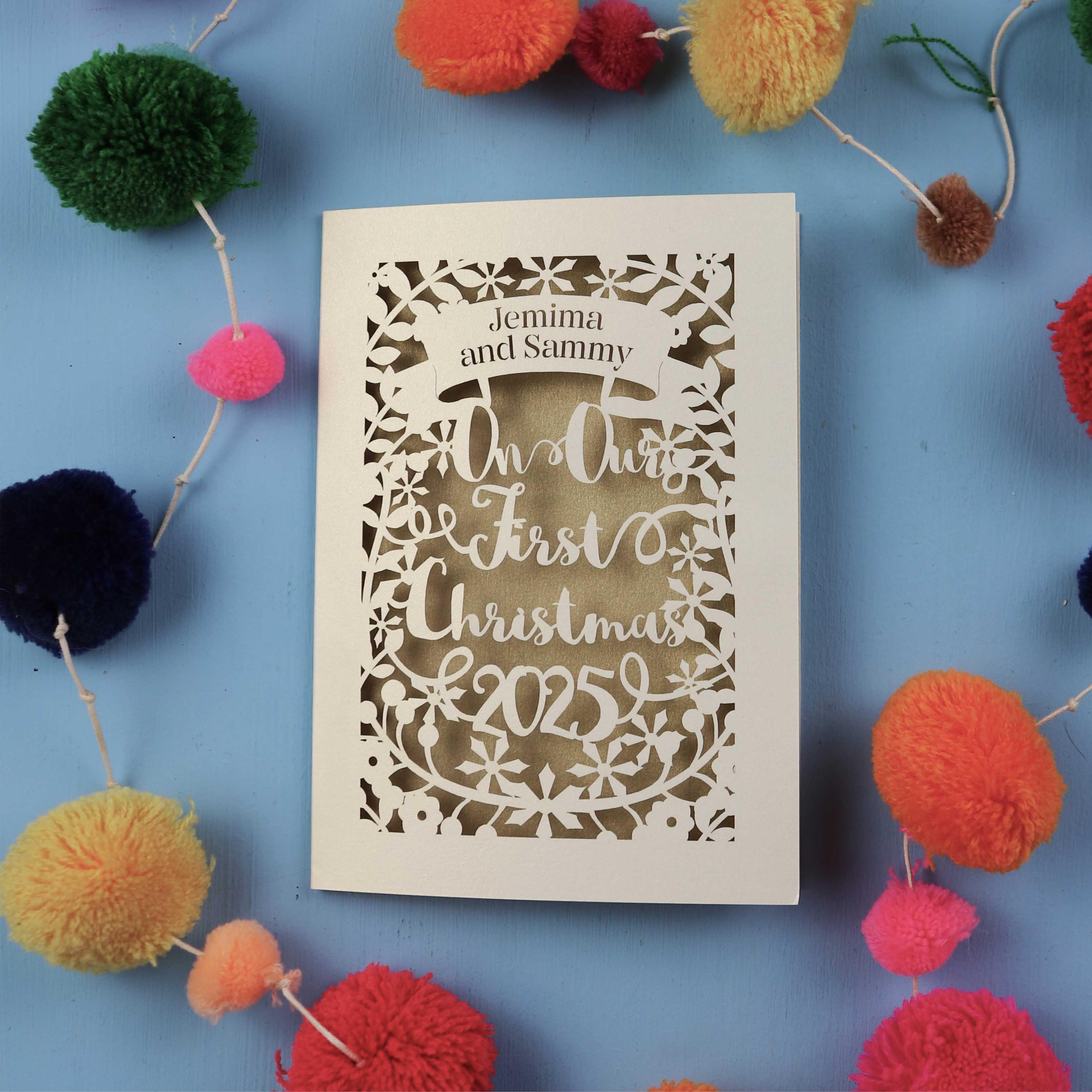 Personalized Our First Christmas card with decorative elements on a blue background