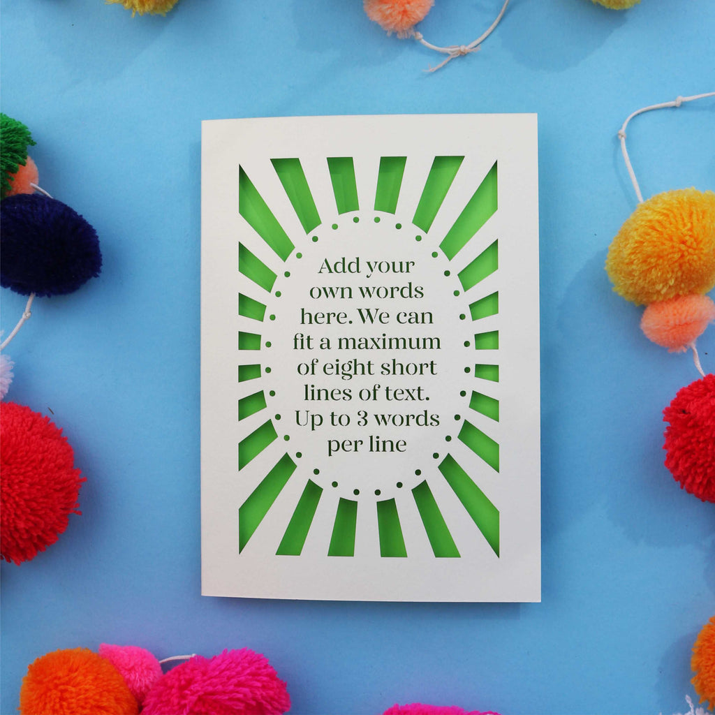 A personalised paper cut card with your own text surrounded by a laser cut border.