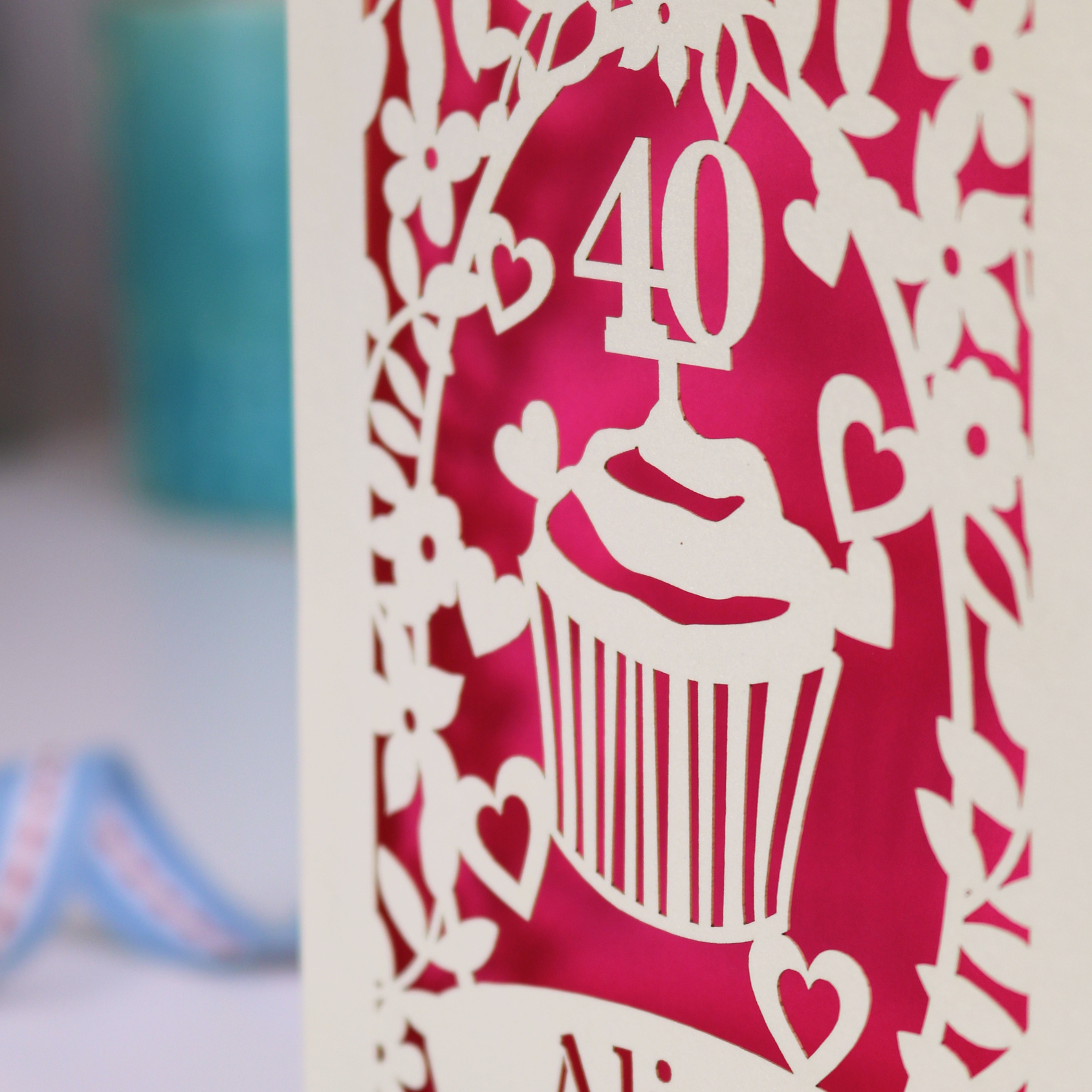 Card with a cupcake and number 40 design on a red background