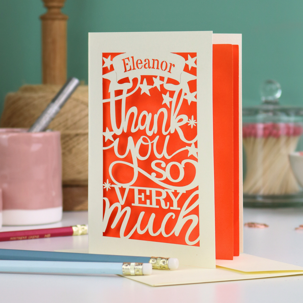 A cream laser cut thank you card with personalised name at the top in a banner, over text 'thank you so very much'