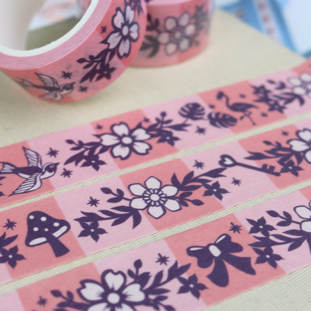 Decorative tape with floral and whimsical-themed designs on a pink background