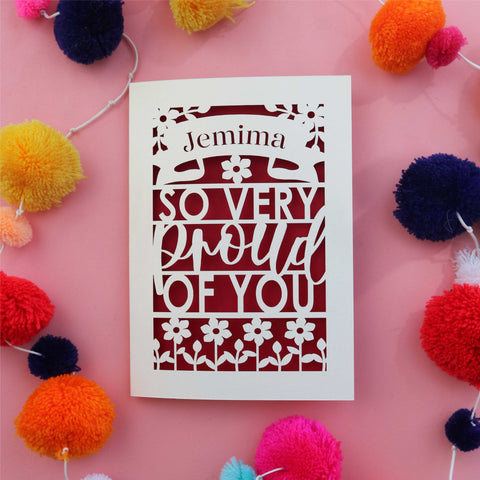 A paper cut celebration card that is personalised with a name and reads "So very proud of you" - A6 (small) / Dark Red