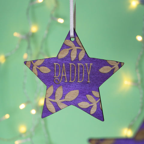 A purple Christmas star decoration, personalised with a name. - 