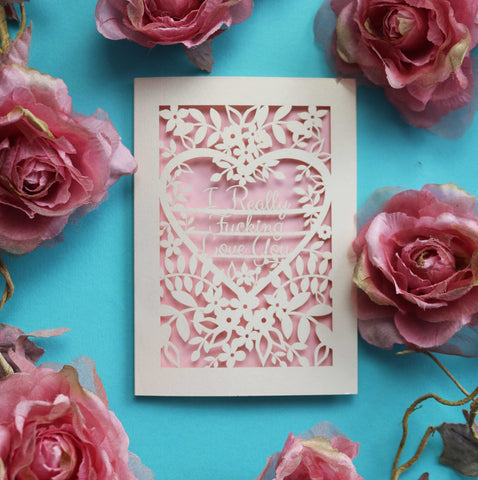 A paper cut Valentine's card that says "I really fucking love you" inside a  heart and surrounded by flowers and leaves - A5 (large) / Candy Pink