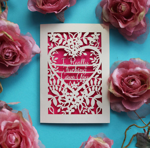 A laser cut card for Valentine's Day that says "I really fucking love you" surrounded by flowers and leaves - A5 (large) / Shocking Pink