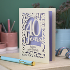 Personalised 40th Anniversary Card with '40 Years' design on a desk with stationery items.