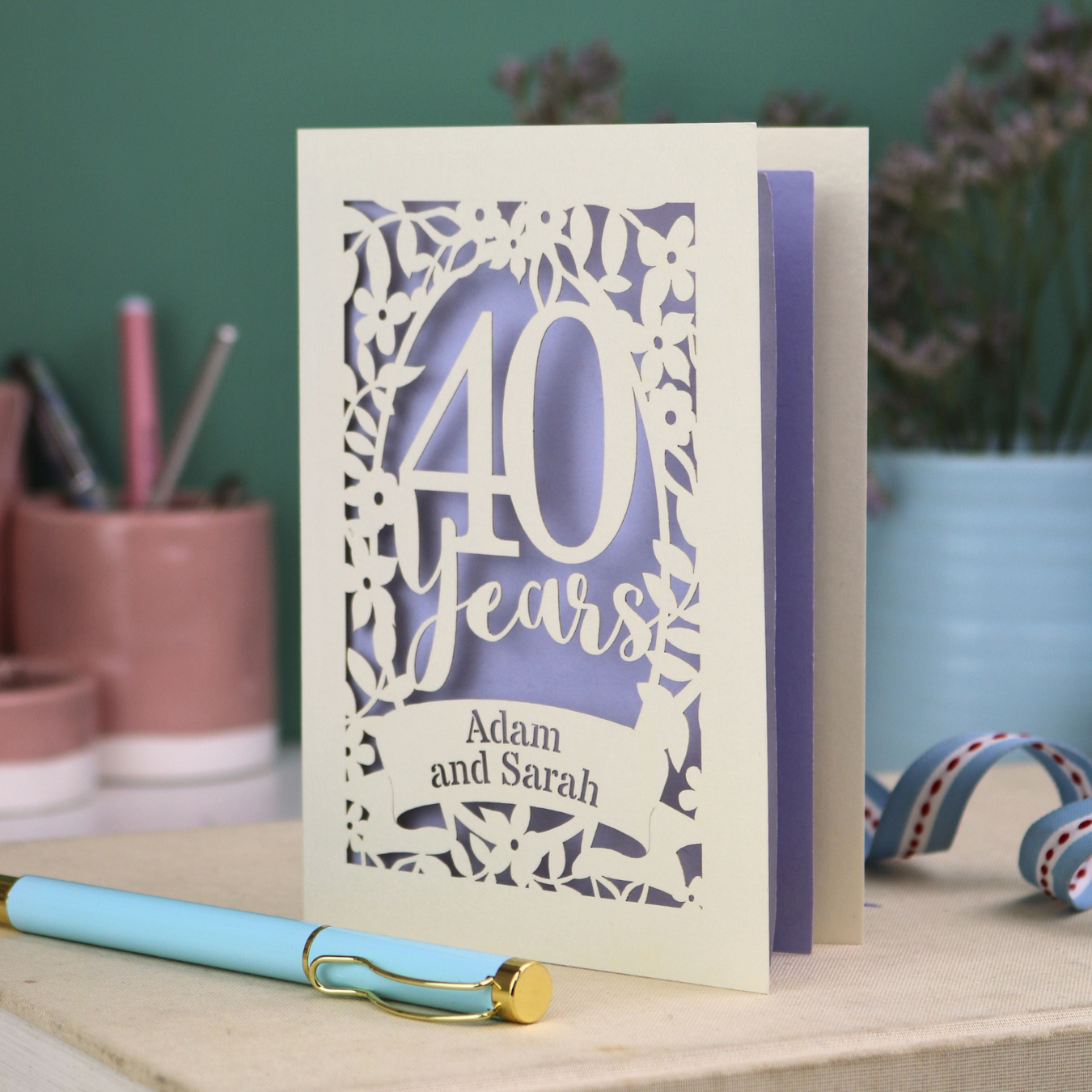 Personalised 40th Anniversary Card with '40 Years' design on a desk with stationery items.