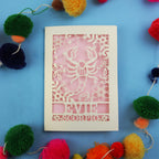 Decorative Scorpio zodiac birthday card with 'Evie Scorpio' design on a blue background with colourful pom-poms.