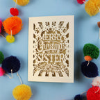 Sister Christmas card with 'Merry Christmas to my sister' text on a blue background with colourful pom-poms.