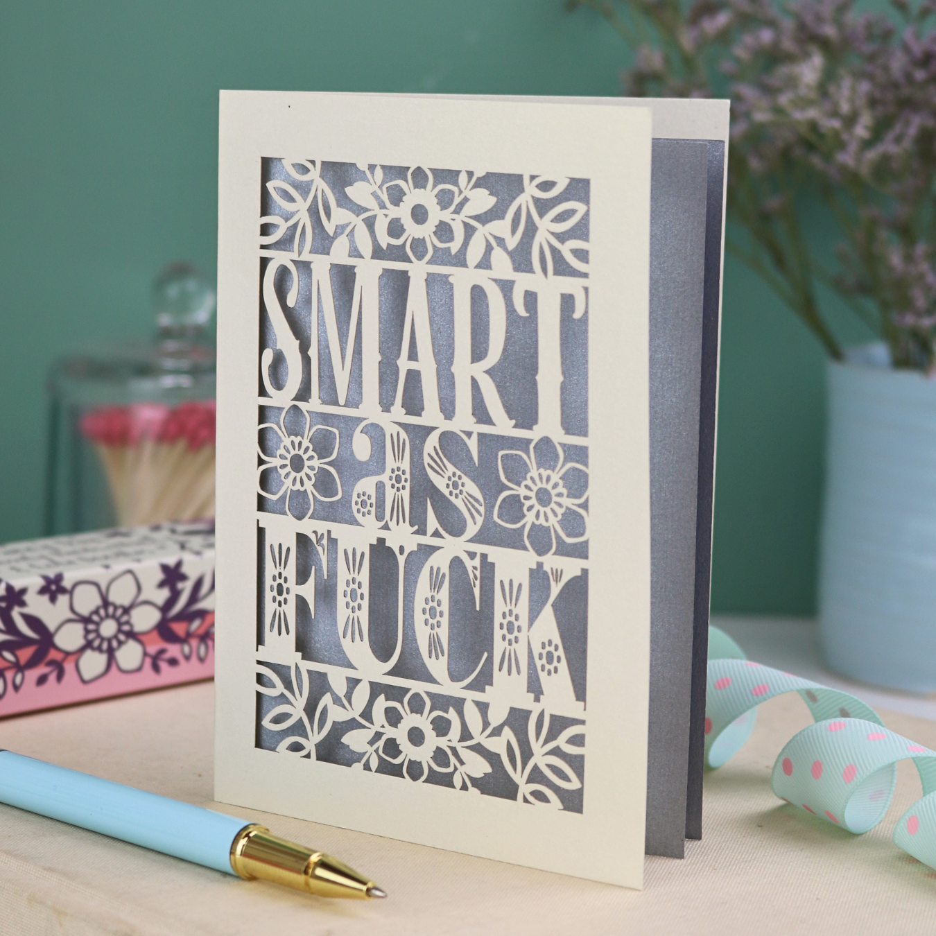 Funny graduation card with rude laser cut text, "Smart as F*ck" and a floral design