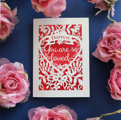 A personalised laser cut Valentine's card that says "Name, you are so loved"