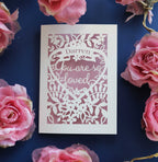 A personalised Valentine's card with cut out details to read "name, you are so loved"
