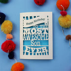 Keepsake Son Birthday Card with 'Happy Birthday to the most awesome son ever' text on a blue background with colourful pom-poms.