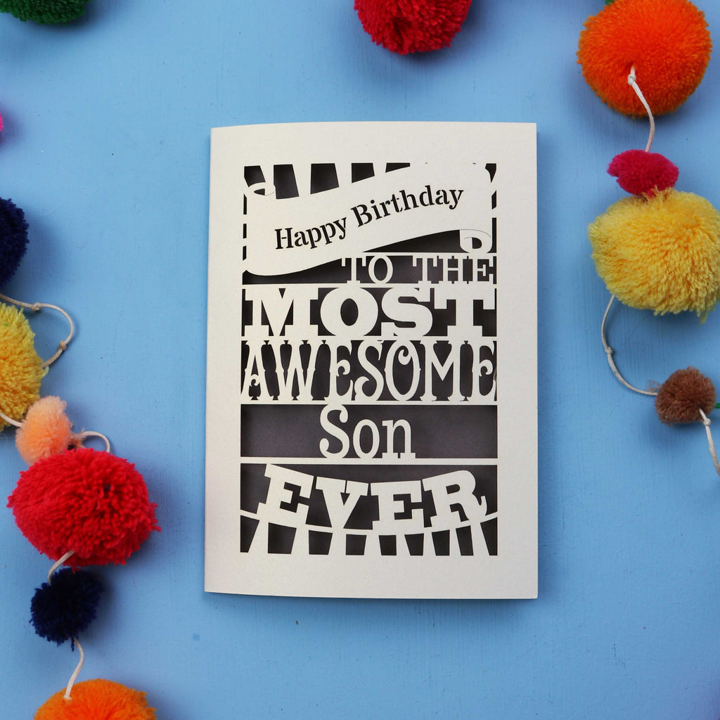 Son Birthday Card with 'Happy Birthday to the most awesome son ever' text on a blue background with colourful pom-poms.