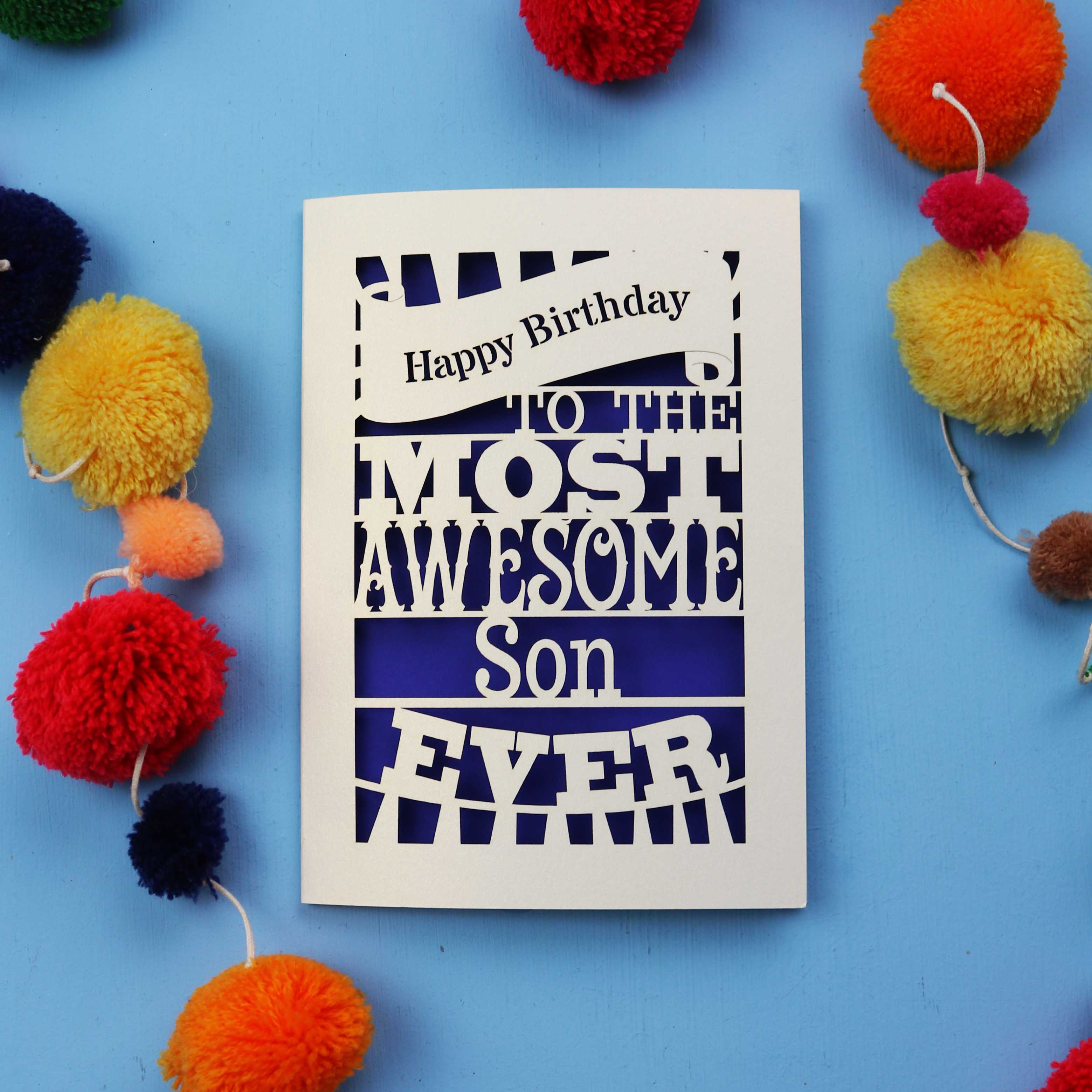 Son Birthday Card with 'Happy Birthday to the most awesome son ever' text on a blue background with colourful pom-poms.