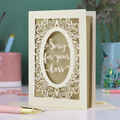 A laser cut sympathy card with "sorry for your loss" text and decorative border