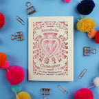 Personalized wedding card with decorative elements on a blue background