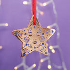 Decorative star Christmas ornament on purple background